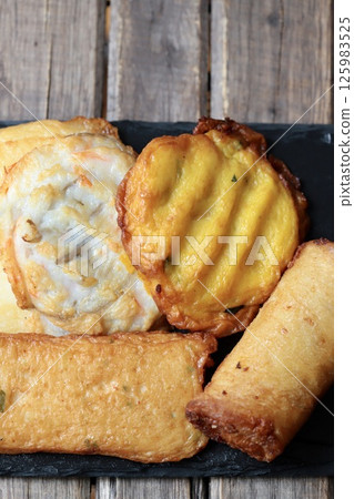 Various types of fried fish cakes served on a slate plate 125983525