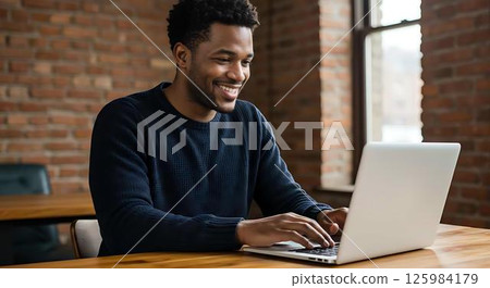 Smiling man working on laptop, cafe 125984179