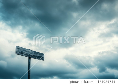 Mysterious empty signpost under cloudy skies in a rural setting during dusk Mysterious empty signpost under cloudy skies in a rural setting during dusk 125985714