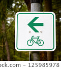 Bicycle lane sign showing left arrow direction in a forest 125985978