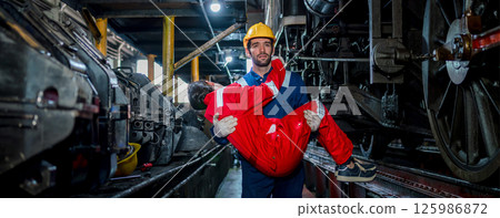 First aid support accident at work of worker at factory. Male worker has an accident on the floor in warehouse site. First aid support accident at work of worker at factory. Male worker has an accident on the floor in warehouse site. 125986872