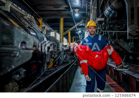 First aid support accident at work of worker at factory. Male worker has an accident on the floor in warehouse site. 125986874
