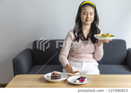 Woman on dieting for good health concept. Woman doing cross arms sign to refuse junk food or fast food 125986923