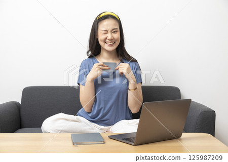 beautiful sad woman at home living room couch calculating monthly expenses worried in stress with bank papers and documents in paying taxes mortgage debt and cost of living concept beautiful sad woman at home living room couch calculating monthly expenses worried in stress with bank papers and documents in paying taxes mortgage debt and cost of living concept 125987209