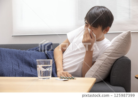 boy blow his nose. Sick child with napkin in bed. Allergic kid, flu season. Kid with cold rhinitis, get cold snot nose boy blow his nose. Sick child with napkin in bed. Allergic kid, flu season. Kid with cold rhinitis, get cold snot nose 125987399