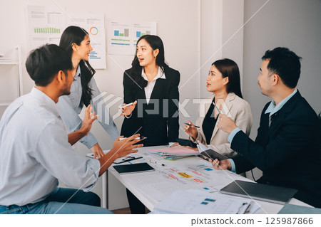 Team of financial advisory services. Asian advisor showing plan of investment to clients in the consultancy office. 125987866