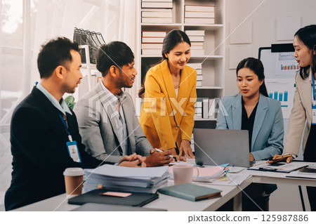 Team of financial advisory services. Asian advisor showing plan of investment to clients in the consultancy office. Team of financial advisory services. Asian advisor showing plan of investment to clients in the consultancy office. 125987886