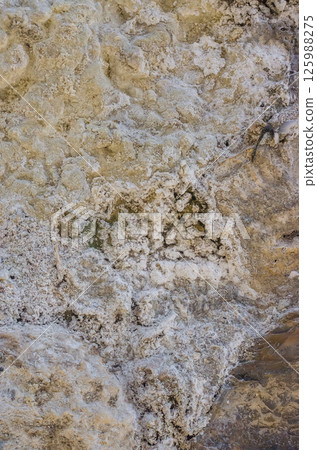 Unique textures of mineral deposits on rocky surface showcasing earthy tones and patterns. High quality photo Unique textures of mineral deposits on rocky surface showcasing earthy tones and patterns. High quality photo 125988275