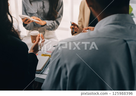 Team of financial advisory services. Asian advisor showing plan of investment to clients in the consultancy office. Team of financial advisory services. Asian advisor showing plan of investment to clients in the consultancy office. 125988396