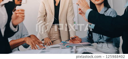 Team of financial advisory services. Asian advisor showing plan of investment to clients in the consultancy office. Team of financial advisory services. Asian advisor showing plan of investment to clients in the consultancy office. 125988402