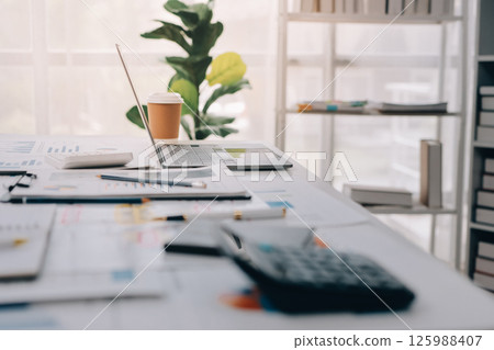 Team of financial advisory services. Asian advisor showing plan of investment to clients in the consultancy office. 125988407