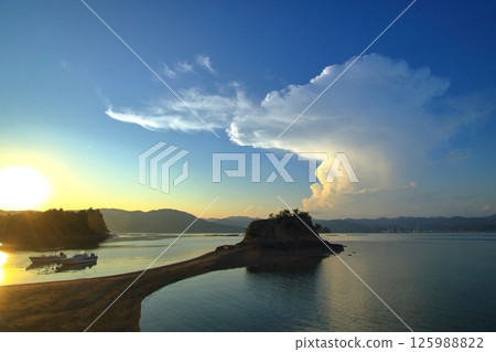 Rising summer clouds and Mont Saint-Michel on Oshiba Island Rising summer clouds and Mont Saint-Michel on Oshiba Island 125988822