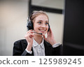 Call center staff are providing business conversation services in the office. 125989245
