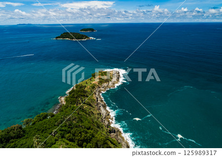 Aerial view Top down seashore, Waves crashing on rocks cliff, Beautiful sea surface in sunny day summer background, Amazing seascape top view seacoast at Phuket Thailand 125989317