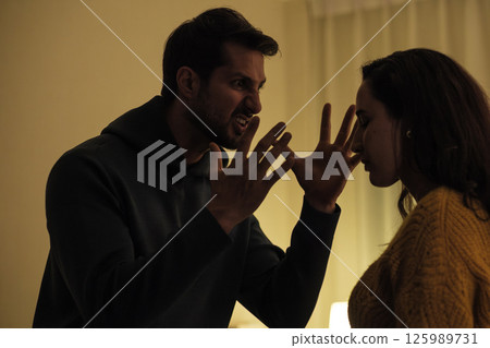 Married couple in emotional conflict and argument at home, fighting through relationship problems and difficult divorce discussions Married couple in emotional conflict and argument at home, fighting through relationship problems and difficult divorce discussions 125989731