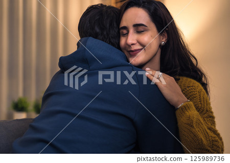 Loving couple hugging romantically together at home, happy in their relationship with deep affection and heartfelt reconciliation 125989736