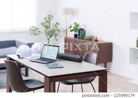 Helmet and laptop in the office (unmanned) 125990174