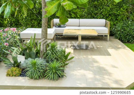 Spring garden at home. Terrace with green plants and trees in small garden. Cozy garden corner with houseplants in pots. Exterior Autumn backyard home. Spring garden at home. Terrace with green plants and trees in small garden. Cozy garden corner with houseplants in pots. Exterior Autumn backyard home. 125990685