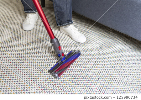 Man doing vacuum cleaning in room Man doing vacuum cleaning in room 125990734