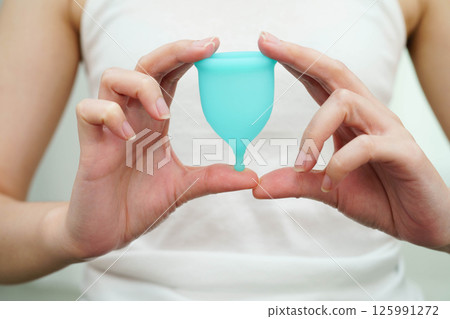 Asian woman holding menstrual cup for hygiene menstrual period cycle protection. Asian woman holding menstrual cup for hygiene menstrual period cycle protection. 125991272