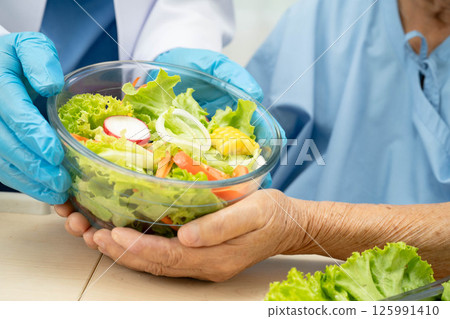 Asian Nutritionist holding healthy food for patient in hospital, nutrition and vitamin. Asian Nutritionist holding healthy food for patient in hospital, nutrition and vitamin. 125991410