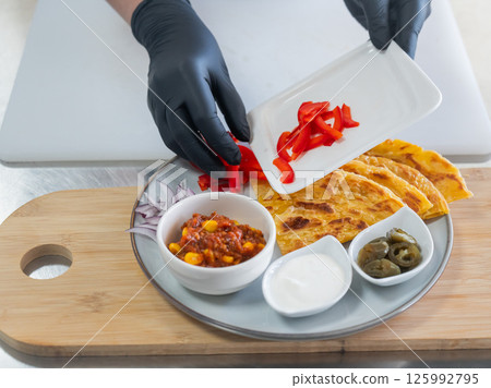 Chef preparing fajitas. Close-up of hands. Chef preparing fajitas. Close-up of hands. 125992795