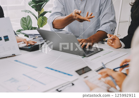 Team of financial advisory services. Asian advisor showing plan of investment to clients in the consultancy office. 125992911