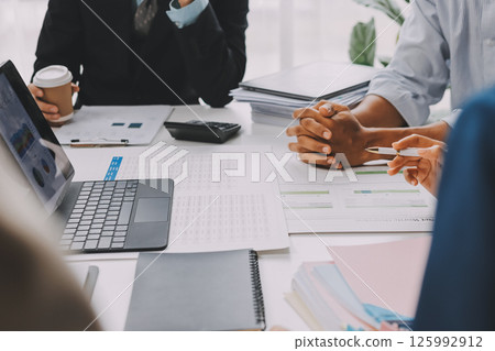 Team of financial advisory services. Asian advisor showing plan of investment to clients in the consultancy office. 125992912