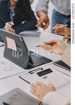 Team of financial advisory services. Asian advisor showing plan of investment to clients in the consultancy office. Team of financial advisory services. Asian advisor showing plan of investment to clients in the consultancy office. 125992914
