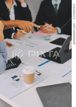 Team of financial advisory services. Asian advisor showing plan of investment to clients in the consultancy office. 125992915