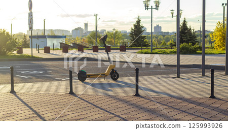 Shot of the rental electric scooter on the street of the city 125993926