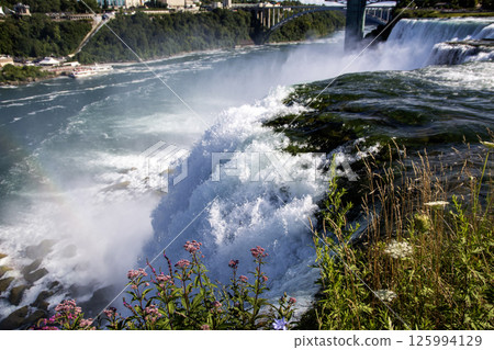Powerfull Waterfall Cascading Into River at Niagara Falls 125994129