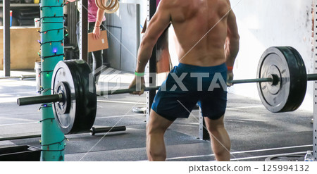 Shirtless Man During a Gym Weightlifting Session for Strength and Fitness 125994132