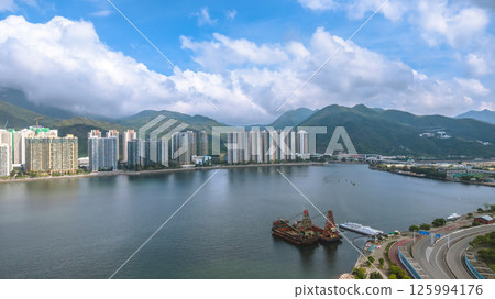 Scenic View of Waterfront City with Mountains and Bright Sky May 4 2025 Scenic View of Waterfront City with Mountains and Bright Sky May 4 2025 125994176