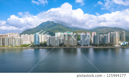 Scenic View of Waterfront City with Mountains and Bright Sky May 4 2025 125994177