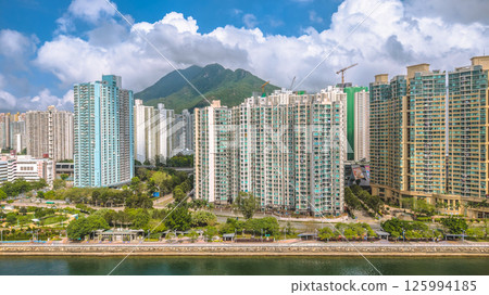 Elevated View of Urban Apartment Buildings Surrounded by Lush Green Hills May 4 2025 Elevated View of Urban Apartment Buildings Surrounded by Lush Green Hills May 4 2025 125994185