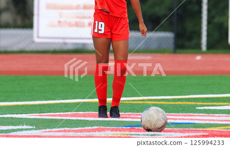 Female Soccer Player Standing Behind the Ball Starting a Play 125994233