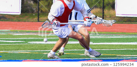 Lacrosse Players Competing for Possession During a Game 125994234