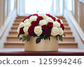 Close-up of a beautiful bouquet featuring red and white roses in a stylish round box. Perfect for Valentines Day, Mothers Day, Birthday, weddings, business for florists, blog post, advertisements 125994246