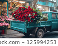 Vintage truck with vibrant red roses near flower market. Flower delivery, Valentines Day, weddings, business promotions for florists, blog post, flower delivery, advertisements. 125994253