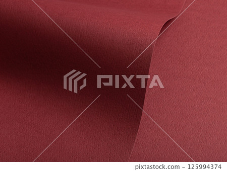 Paper texture with maroon tone, clean wavy fold and perforated surface, deep red designer paper 125994374