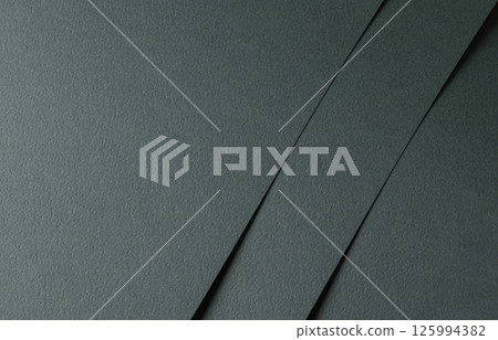 Paper texture with dark green tone, layered sheet and geometric line overlay, clean matte surface 125994382
