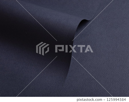 Paper texture with dark blue tone, clean matte surface and wavy folded composition, geometric line 125994384