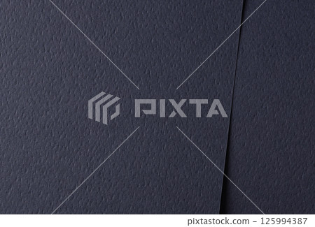 Paper texture with dark blue tone, clean matte surface and perforated geometric line overlay, 125994387