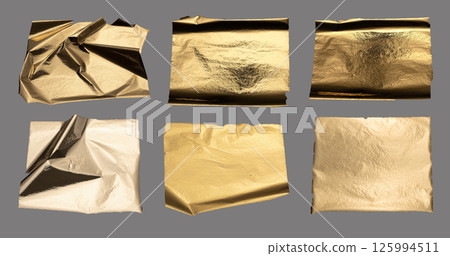 Torn and crumpled metallic foil with textured surface, golden and bronze tones, edgy jagged edges, 125994511