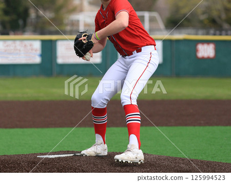 Baseball pitcher on the mound throwing a pitch during a game 125994523