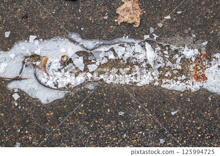 Concept shot of the cracked ice on ground Concept shot of the cracked ice on ground 125994725