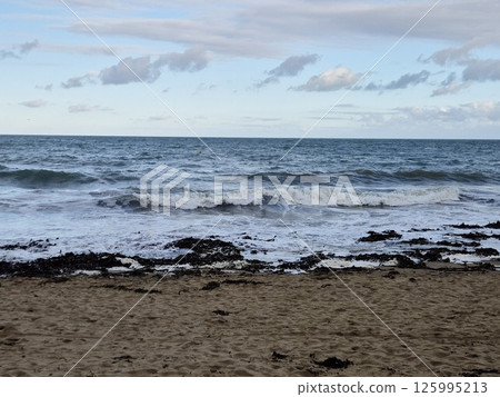 Calm Azure Beach with Cumulus Clouds and Gentle Waves Calm Azure Beach with Cumulus Clouds and Gentle Waves 125995213