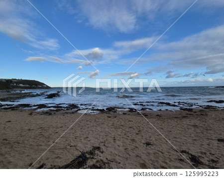 Dusk Beach Landscape with Water and Cumulus Clouds Dusk Beach Landscape with Water and Cumulus Clouds 125995223