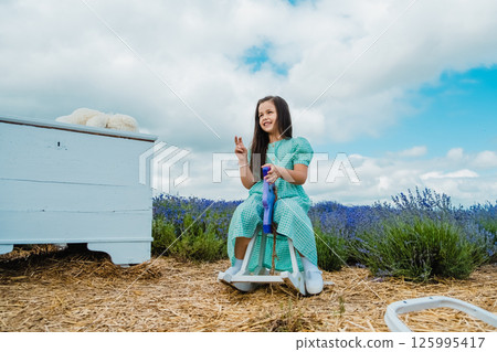 Girl swinging on a purple toy horse. Girl swinging on a purple toy horse. 125995417